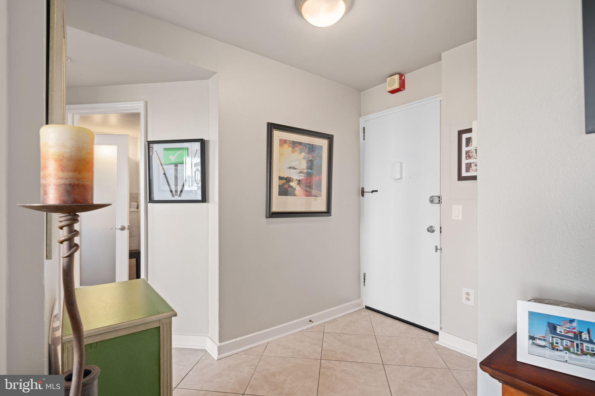 2601 Pennsylvania Avenue, Unit 846 Philadelphia, PA 19130 - Photo 22 of 40 a view of a hallway with workspace and mirror on the wall