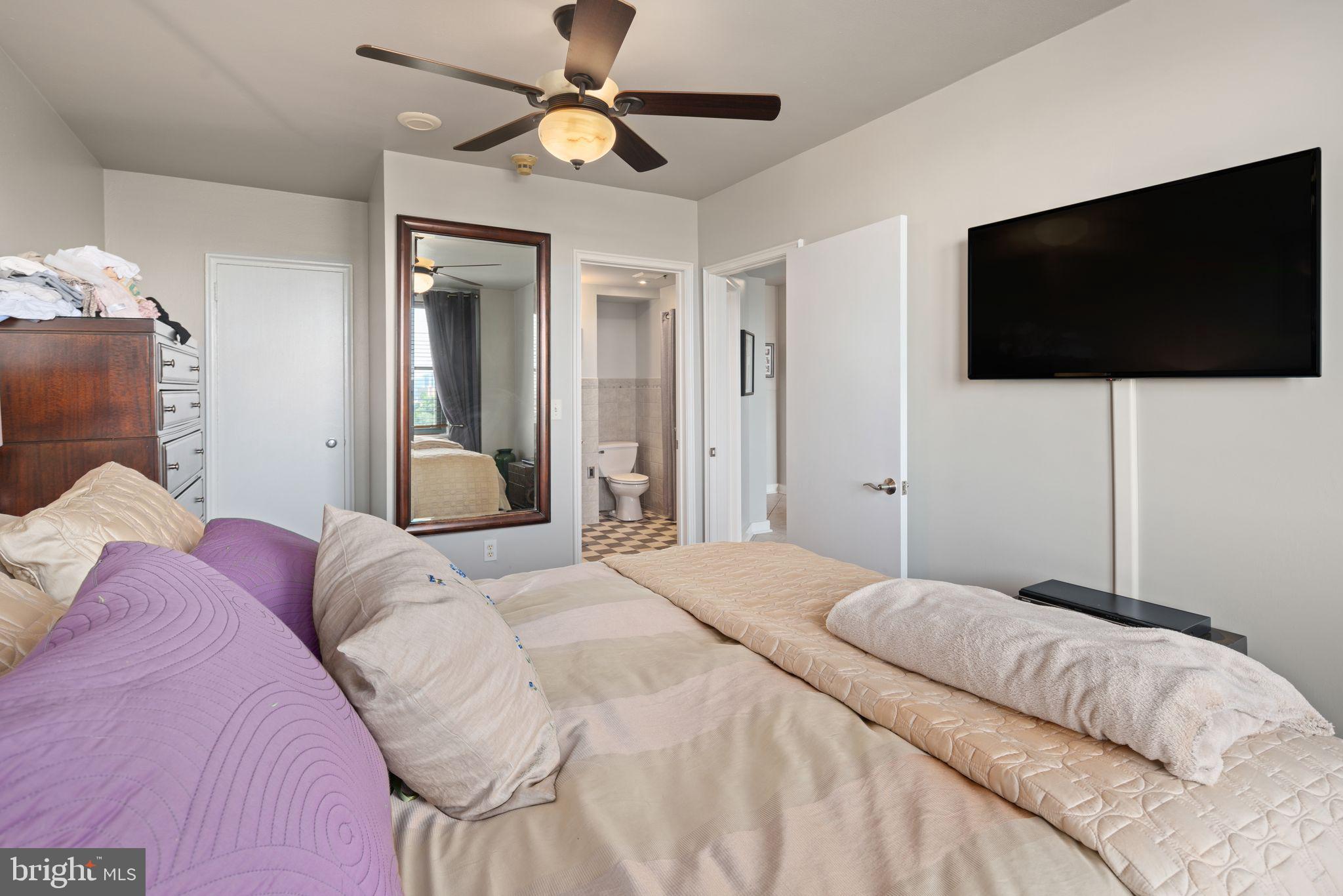 2601 Pennsylvania Avenue, Unit 846 Philadelphia, PA 19130 - Photo 28 of 40 a bedroom with a large bed and a flat screen tv