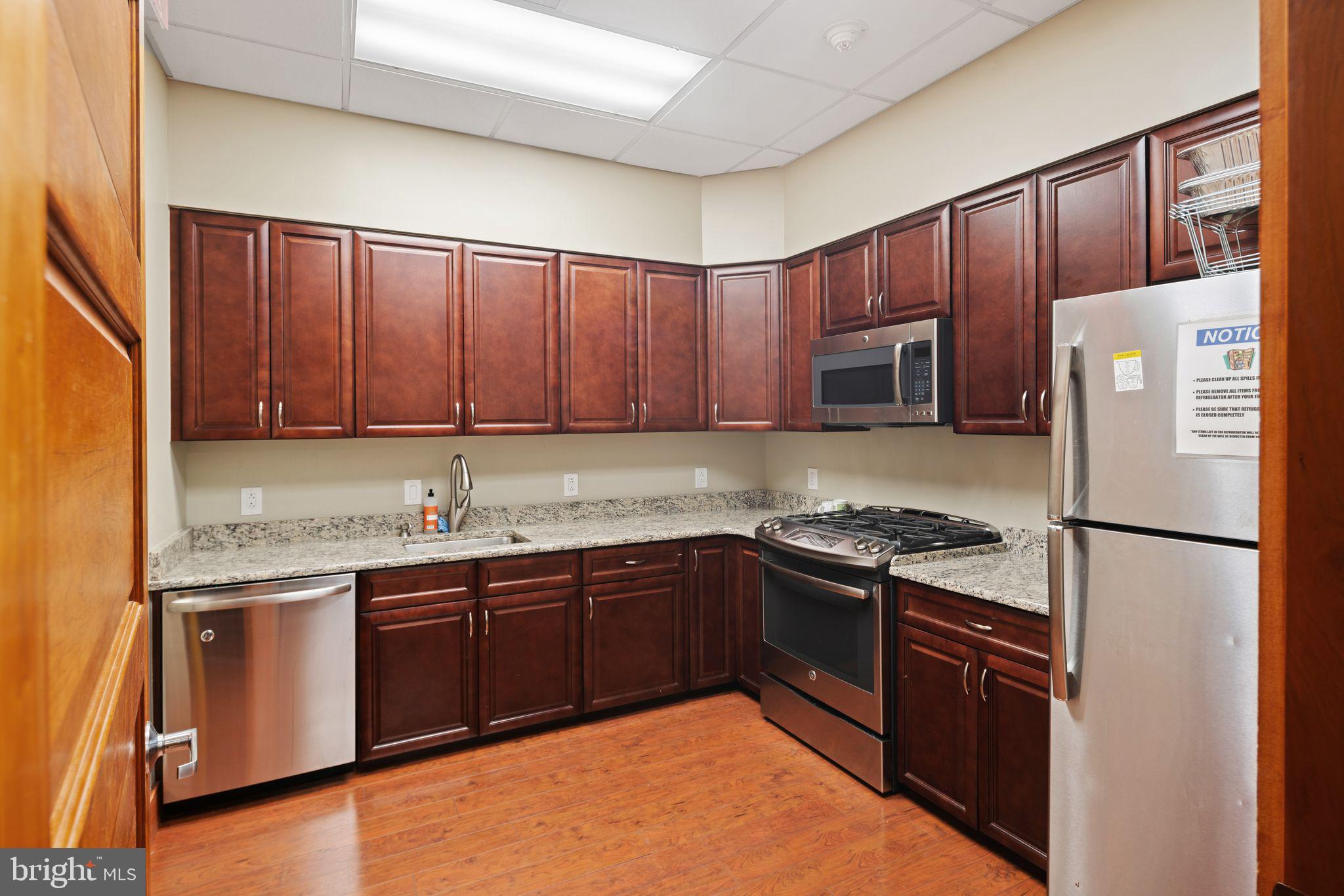 2601 Pennsylvania Avenue, Unit 846 Philadelphia, PA 19130 - Photo 32 of 40 a kitchen with granite countertop stainless steel appliances and wooden cabinets