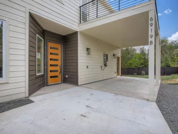 a view of a house with a yard and garage