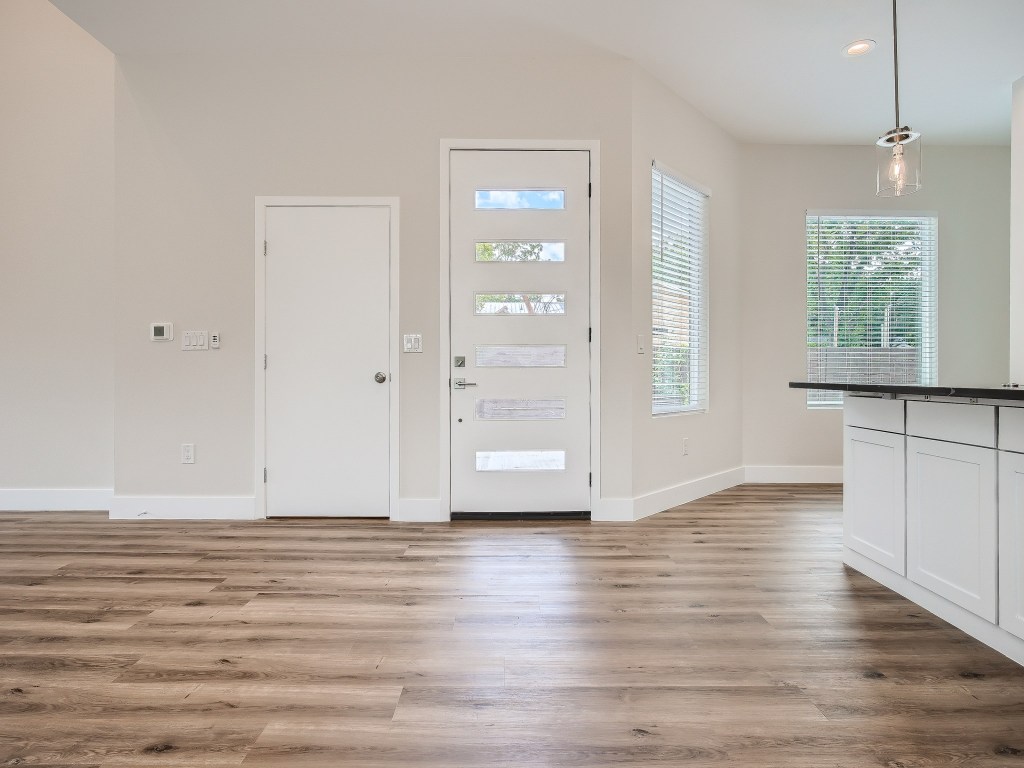 6919 Bethune Avenue, Unit B Austin, TX 78752 - Photo 3 of 17 a view of an empty room with window and wooden floor