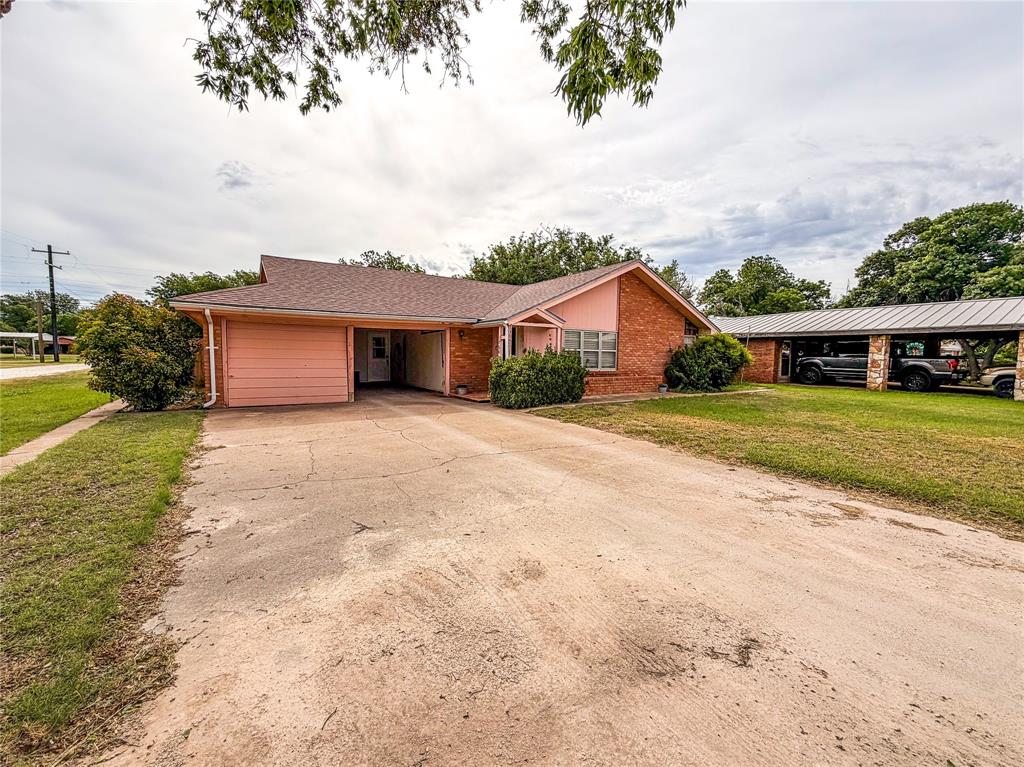 1706 North Ave H Haskell, TX 79521 - Photo 2 of 25 a view of a house with a yard and potted plants