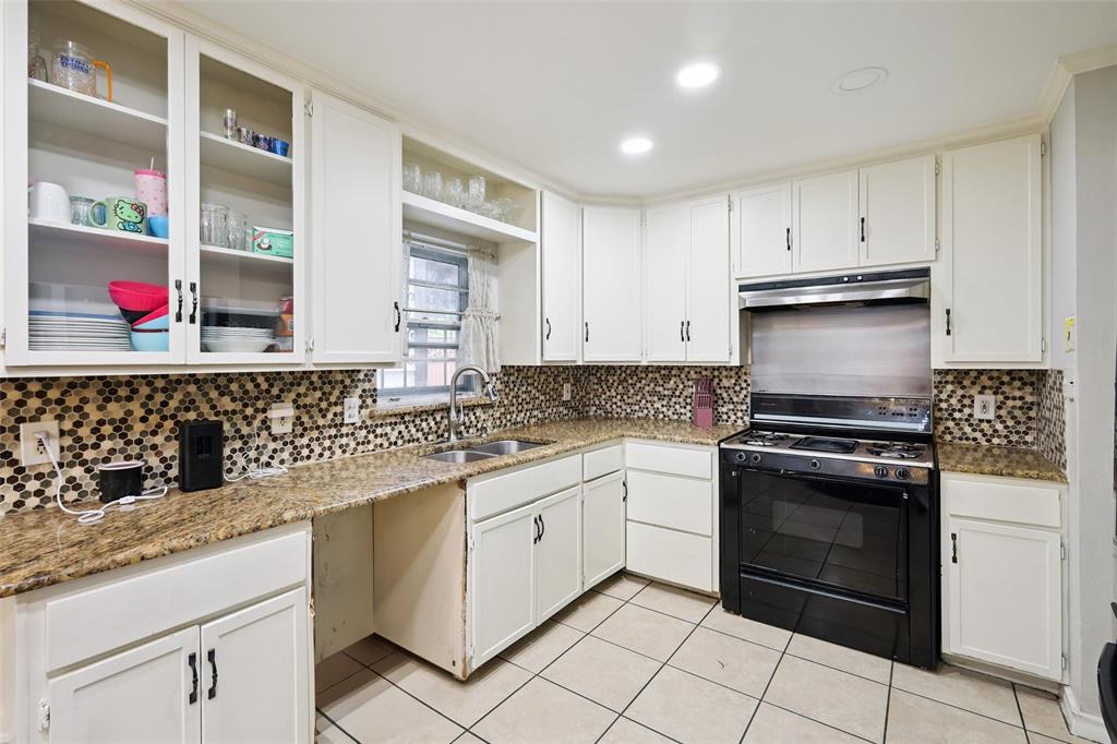 10505 Ferguson Road Dallas, TX 75228 - Photo 12 of 29 a kitchen with white cabinets and appliances