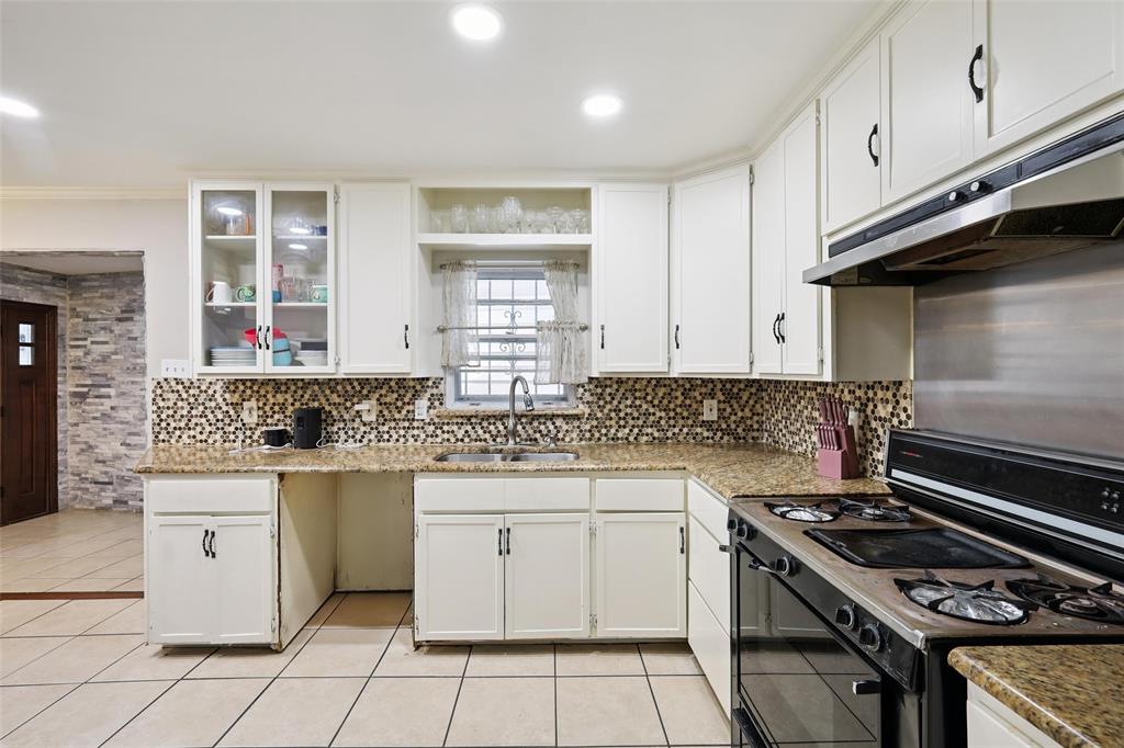 10505 Ferguson Road Dallas, TX 75228 - Photo 14 of 29 a kitchen with granite countertop a stove sink and cabinets
