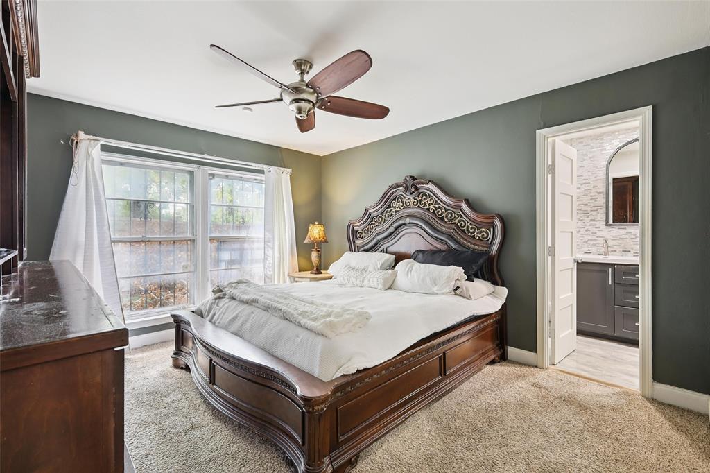 10505 Ferguson Road Dallas, TX 75228 - Photo 15 of 29 a bed sitting in a bedroom next to a window