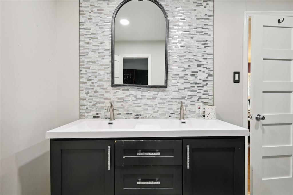 10505 Ferguson Road Dallas, TX 75228 - Photo 16 of 29 a bathroom with a sink and a mirror