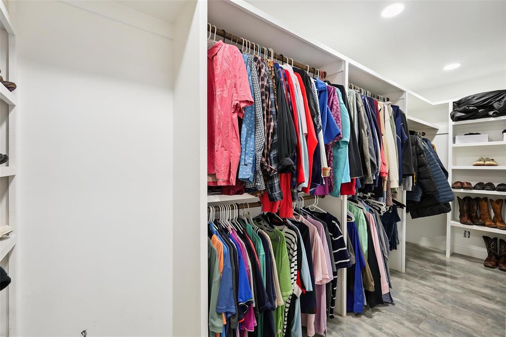 10505 Ferguson Road Dallas, TX 75228 - Photo 19 of 29 a view of walk in closet with clothes