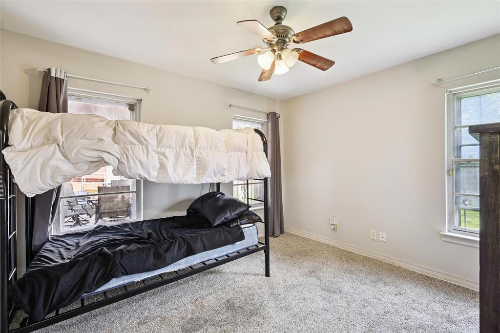 10505 Ferguson Road Dallas, TX 75228 - Photo 20 of 29 a living room with a couch and a chandelier