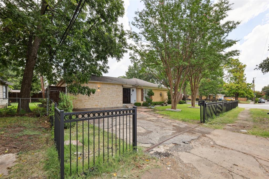10505 Ferguson Road Dallas, TX 75228 - Photo 2 of 29 a view of a house with a backyard and trees