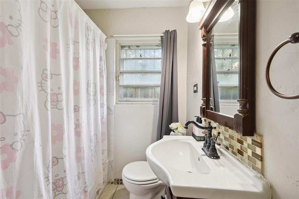 10505 Ferguson Road Dallas, TX 75228 - Photo 21 of 29 a bathroom with a sink toilet and shower