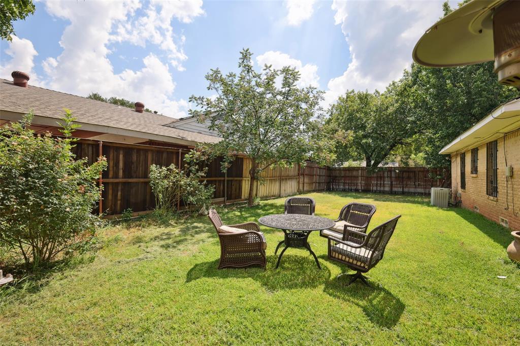 10505 Ferguson Road Dallas, TX 75228 - Photo 25 of 29 a backyard of a house with table and chairs