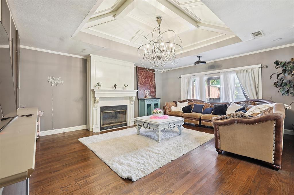10505 Ferguson Road Dallas, TX 75228 - Photo 5 of 29 a living room with furniture a chandelier and a fireplace