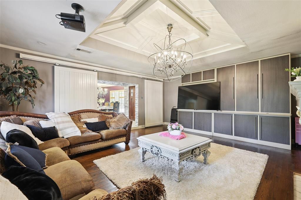 10505 Ferguson Road Dallas, TX 75228 - Photo 6 of 29 a living room with furniture a chandelier and a flat screen tv