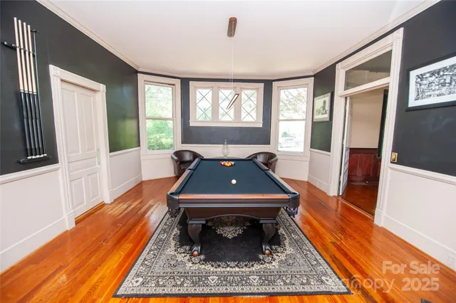 a living room with furniture rug and wooden floor