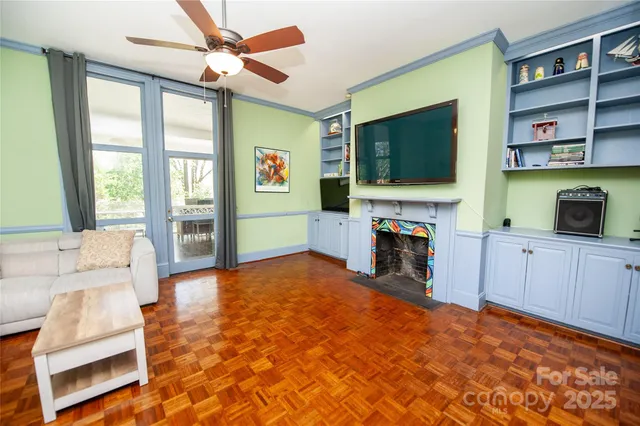 a living room with fireplace furniture and a flat screen tv
