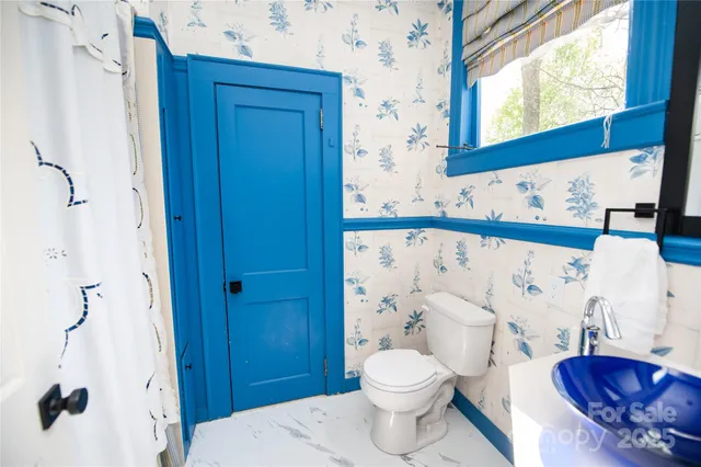 a kitchen with a sink a bed and cabinets