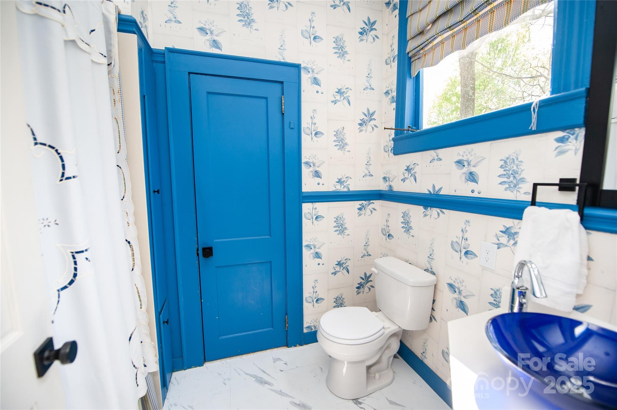 447 North Washington Street Rutherfordton, NC 28139 - Photo 33 of 48 a bathroom with a toilet a sink and a window