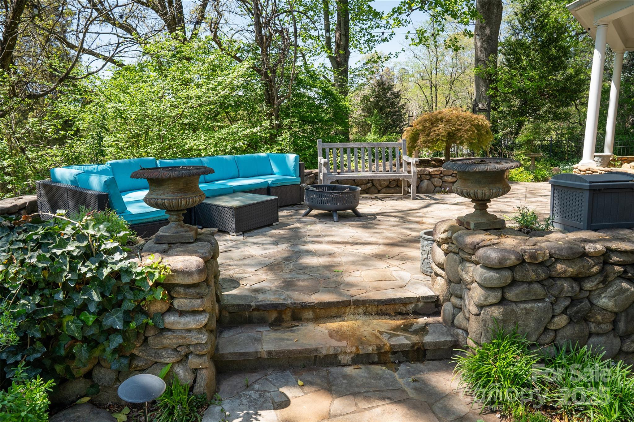 447 North Washington Street Rutherfordton, NC 28139 - Photo 39 of 48 a backyard of a house with table and chairs potted plants and large tree