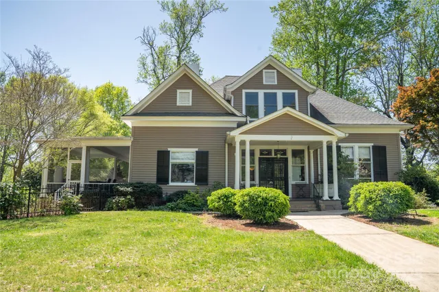an aerial view of a house with yard
