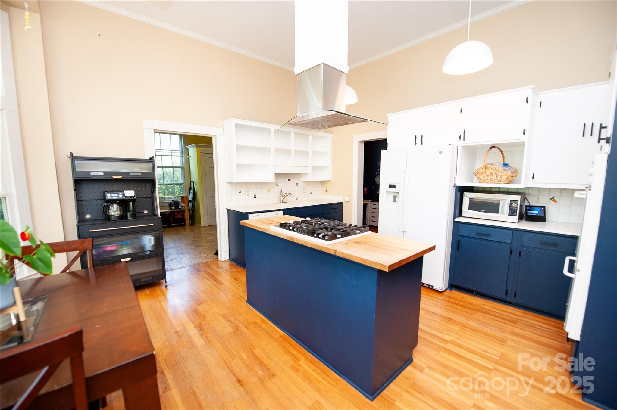 447 North Washington Street Rutherfordton, NC 28139 - Photo 9 of 48 a kitchen with stainless steel appliances a stove top oven a sink refrigerator and a dining table with wooden floor