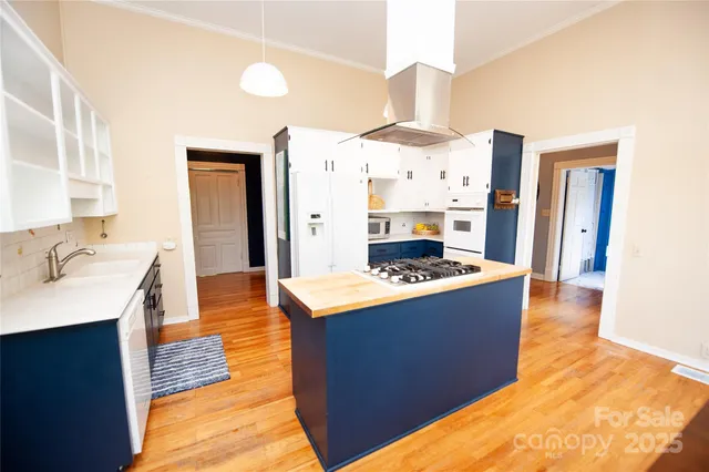 a large kitchen with stainless steel appliances a stove and a refrigerator