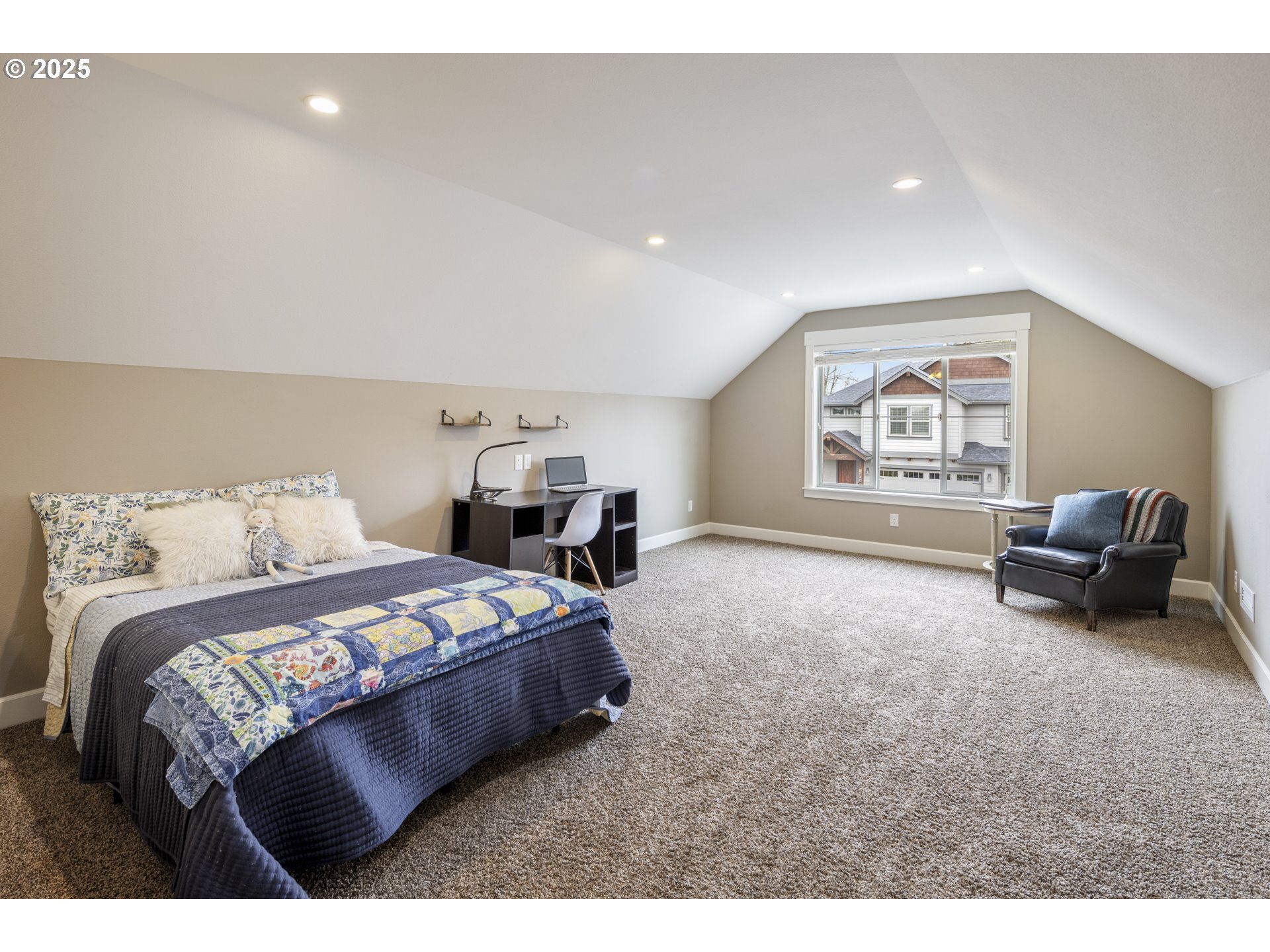4841 North 8th Street Ridgefield, WA 98642 - Photo 26 of 48 a bedroom with a bed couch and a large window