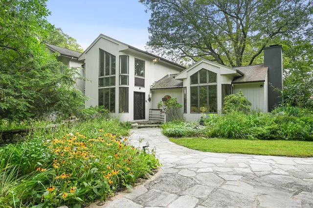 a front view of a house with a garden