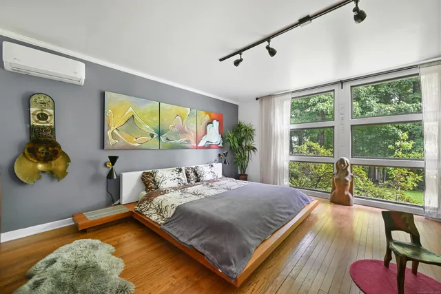 a bedroom with a bed and wooden floor