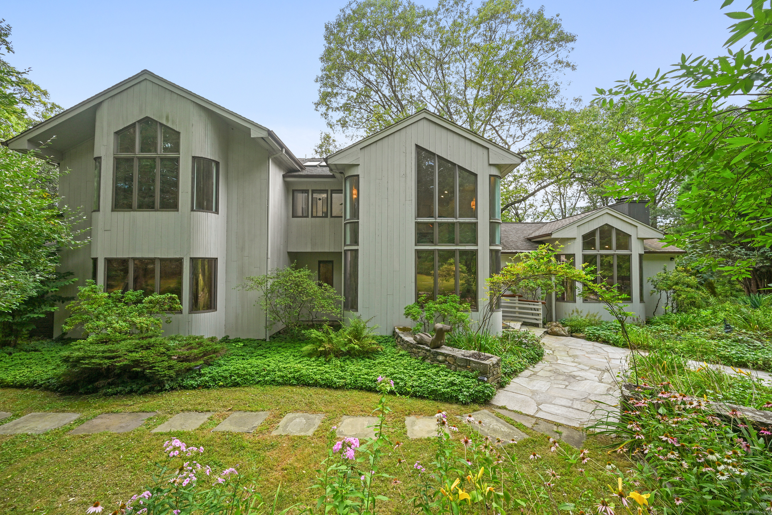61 Marchant Road Redding, CT 06896 - Photo 2 of 38 a front view of a house with a yard and porch