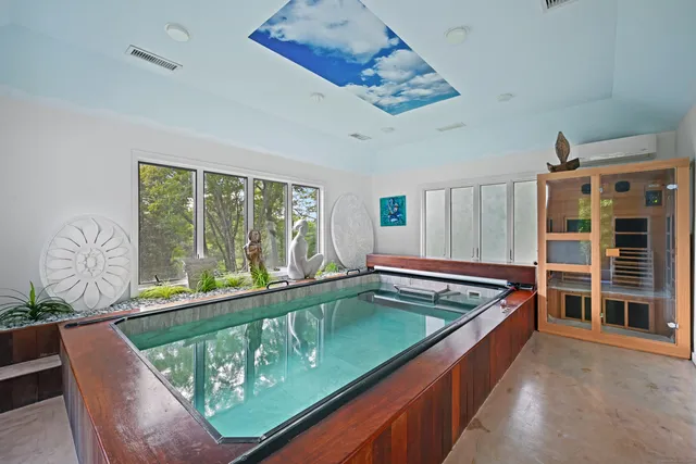 a bathroom with a bathtub a sink and a mirror