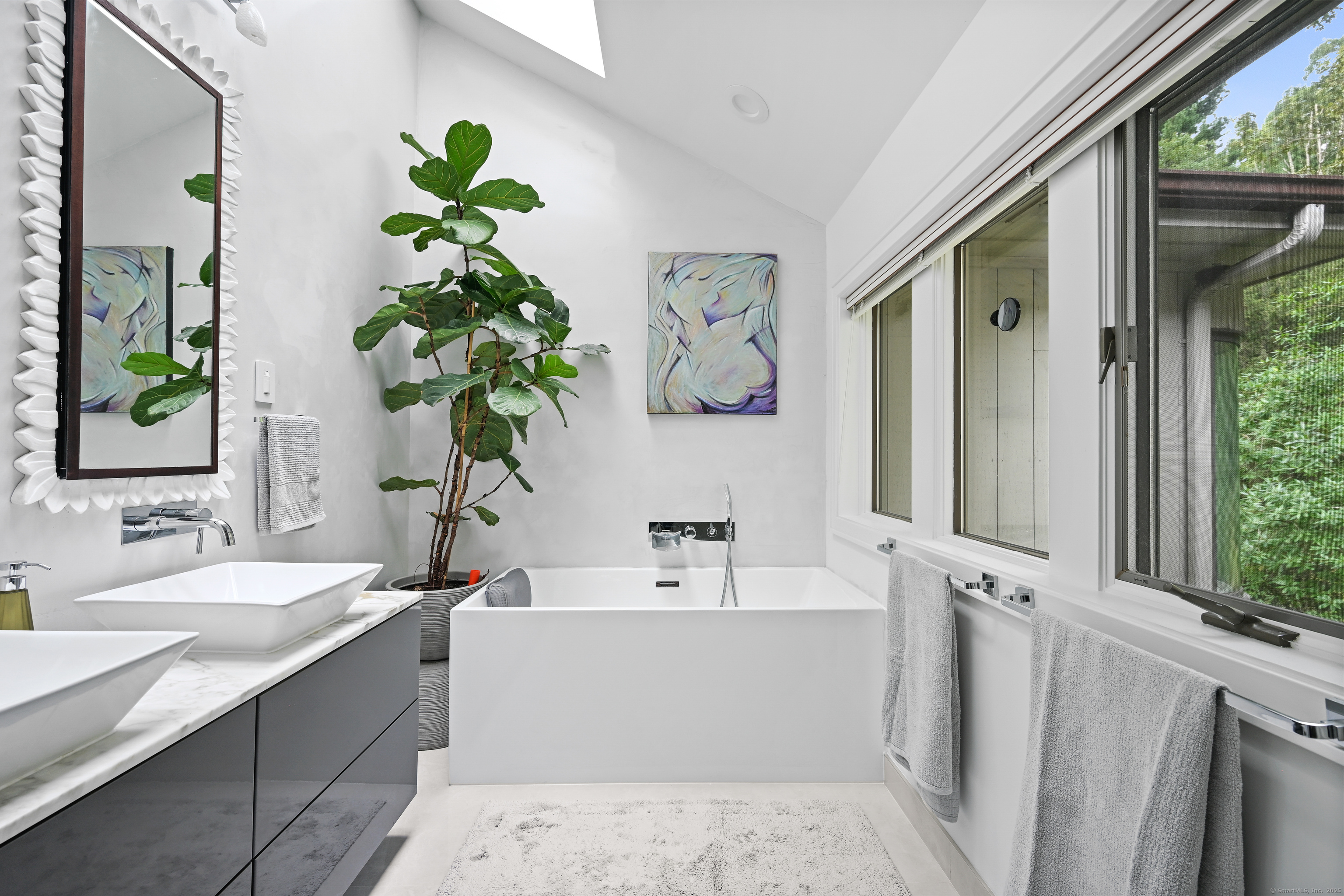 61 Marchant Road Redding, CT 06896 - Photo 23 of 38 a bathroom with a bathtub a sink and a mirror