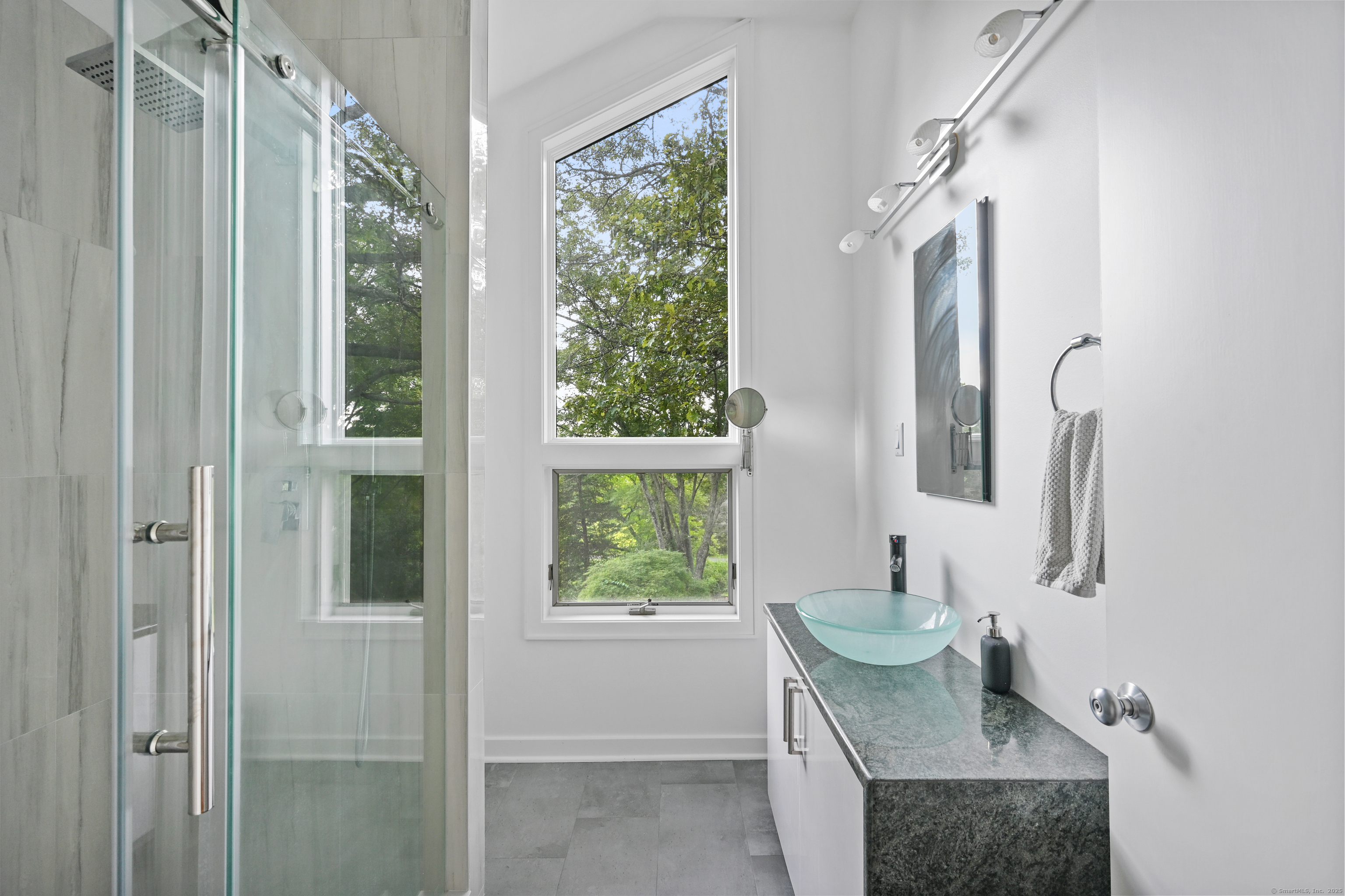 61 Marchant Road Redding, CT 06896 - Photo 27 of 38 a bathroom with a granite countertop sink a toilet and a window