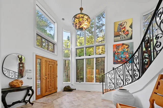 a view of an entryway with wooden floor and windows