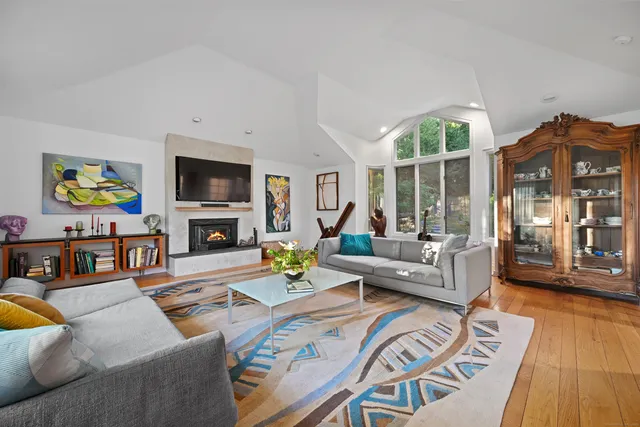 a living room with fireplace furniture and a wooden floor