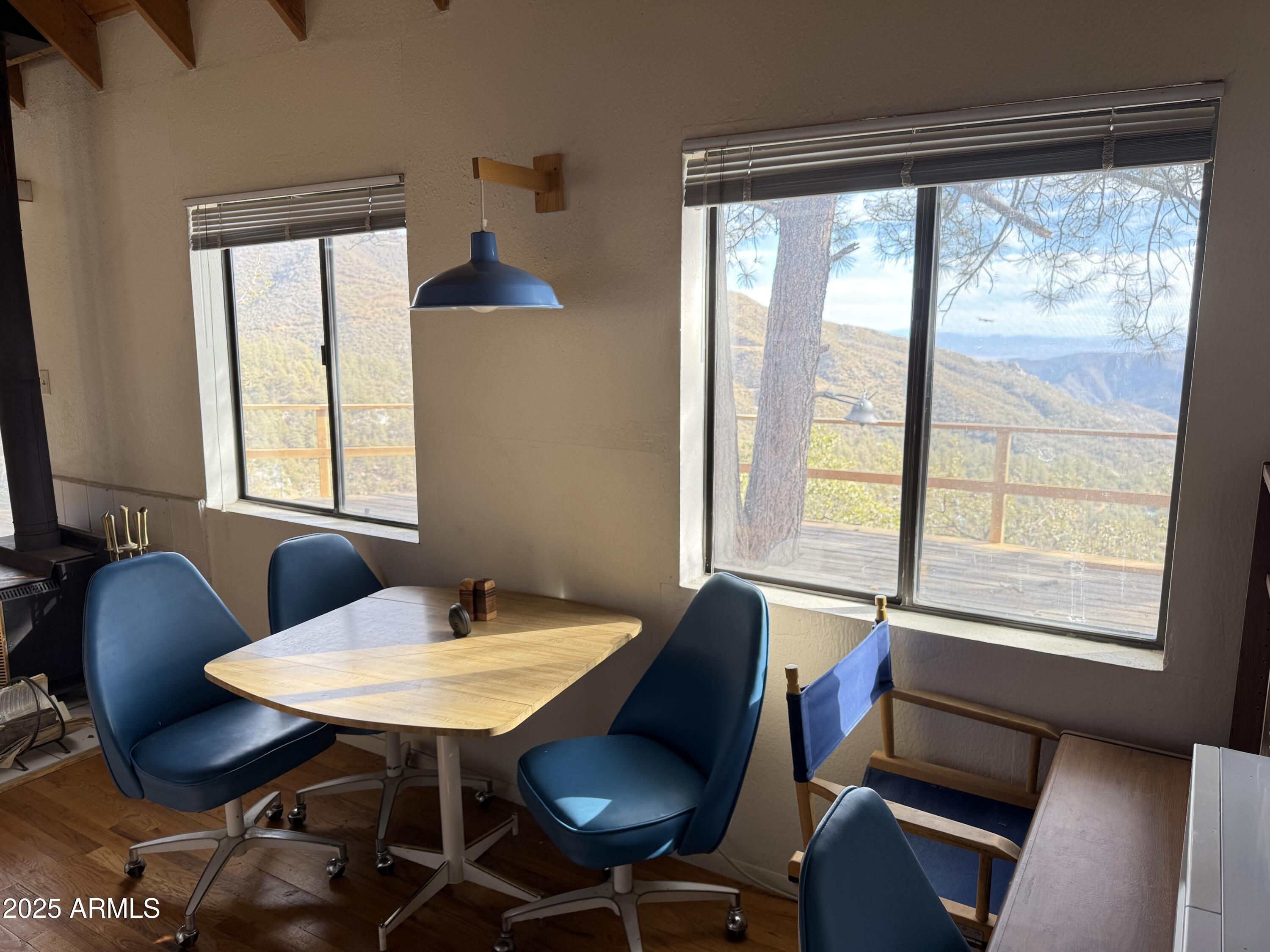 6358 Mountain View Road Crown King, AZ 86343 - Photo 28 of 42 a view of a dining room with furniture and window