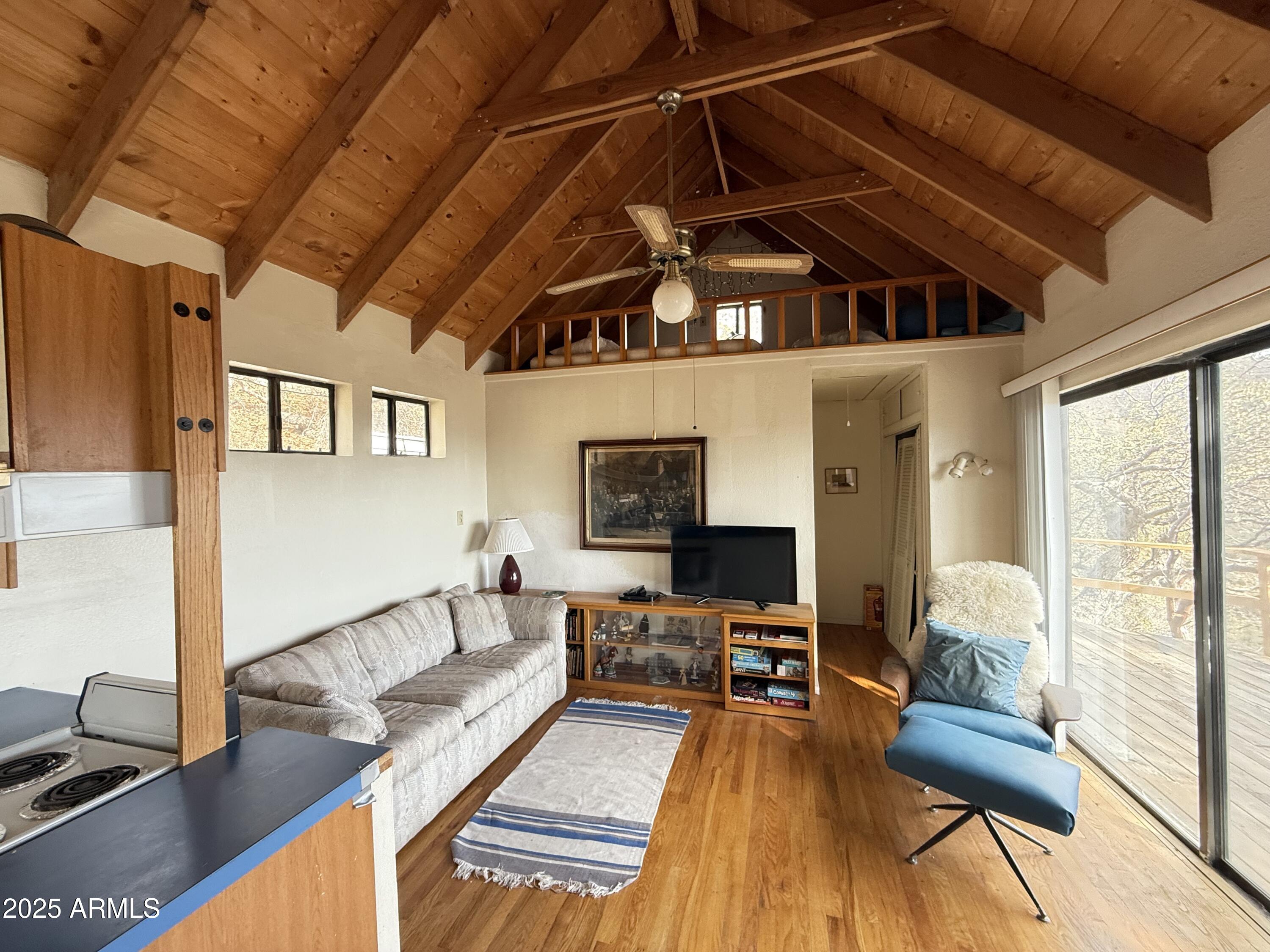 6358 Mountain View Road Crown King, AZ 86343 - Photo 7 of 42 a living room with furniture and a flat screen tv