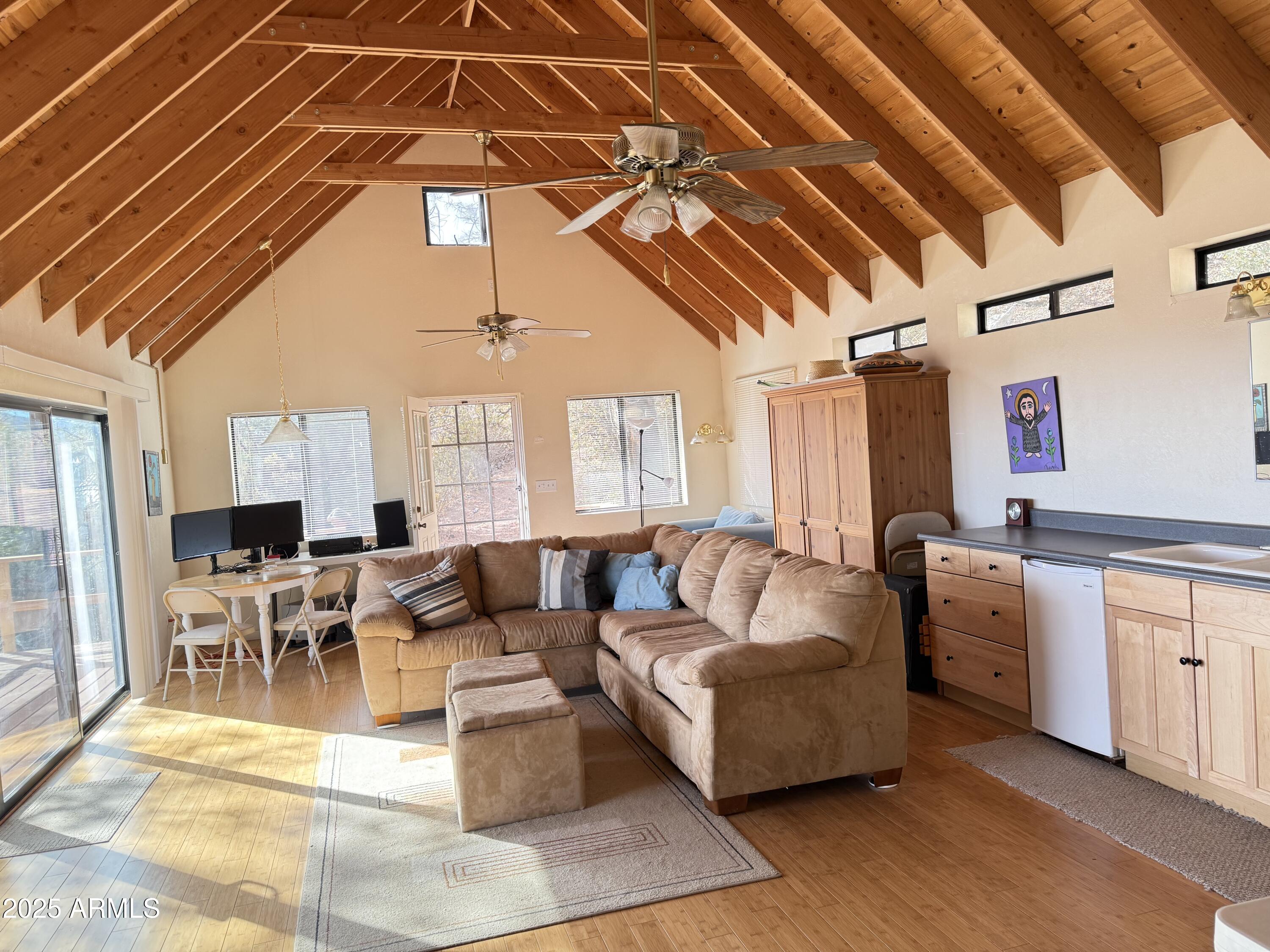 6358 Mountain View Road Crown King, AZ 86343 - Photo 10 of 42 a living room with furniture and a chandelier