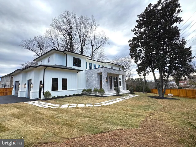 a view of a house with a yard covered in snow