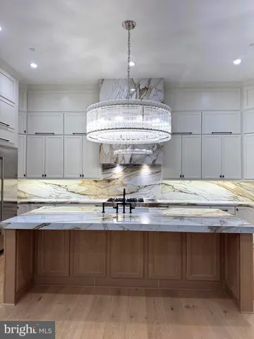 a kitchen with a sink a stove and cabinets
