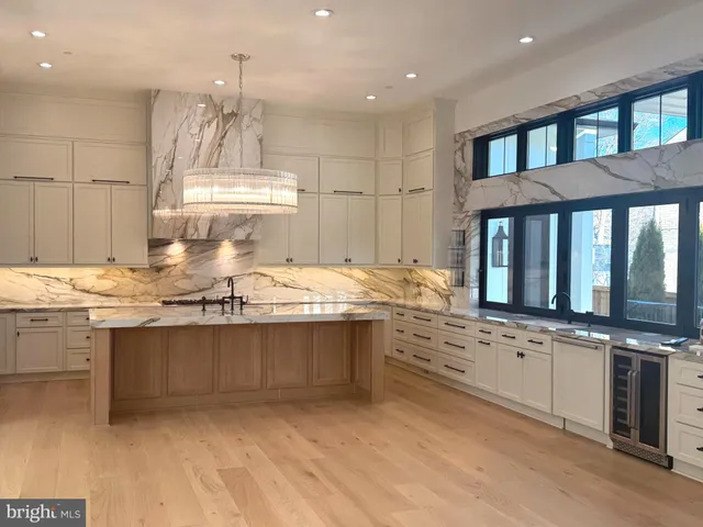 a kitchen with kitchen island granite countertop a sink counter top space and stainless steel appliances