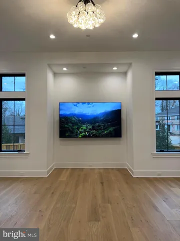 a view of a room with wooden floor and entryway