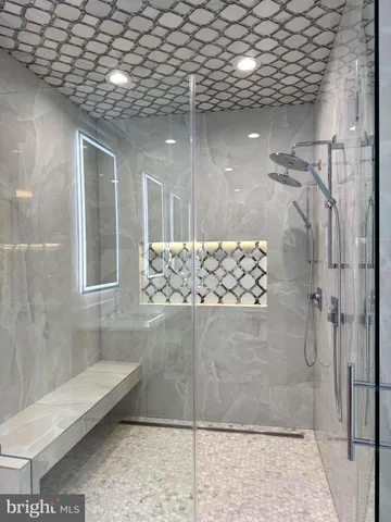 a bathroom with a glass shower door