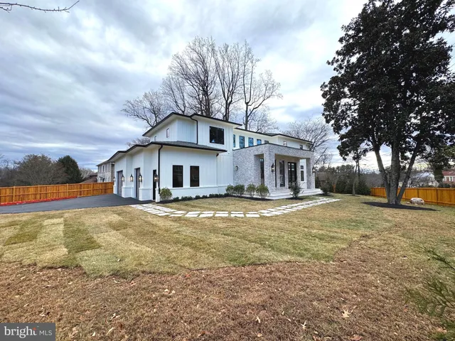 a view of a house with a yard covered in snow