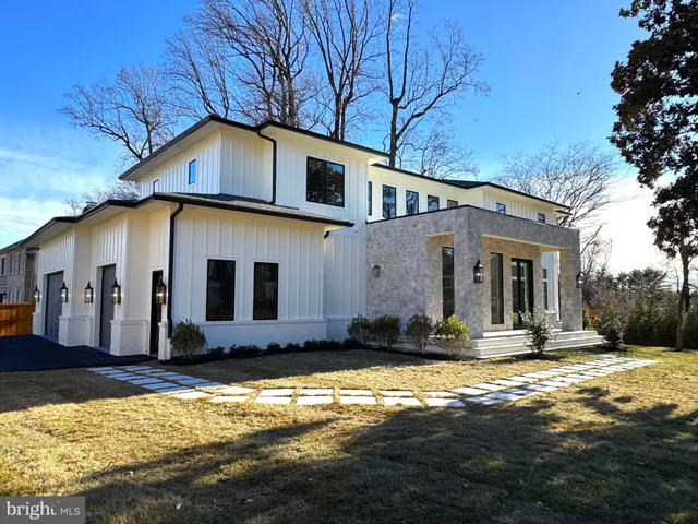 a view of a house with swimming pool and sitting area