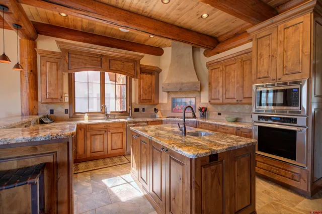 a kitchen with sink stove and cabinets