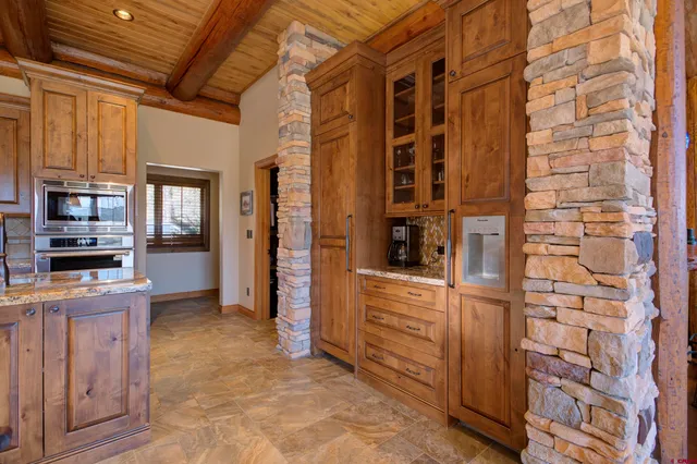a spacious bedroom with a bed and wooden floor