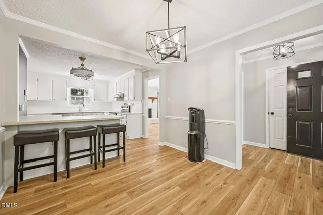 a very nice looking room with a wooden floor and a kitchen space