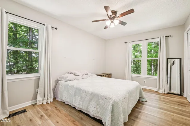 a bedroom with a large bed and a large window