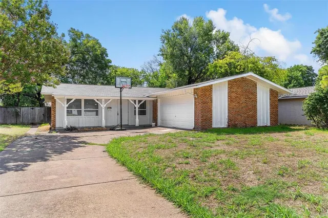 a front view of house with yard and trees