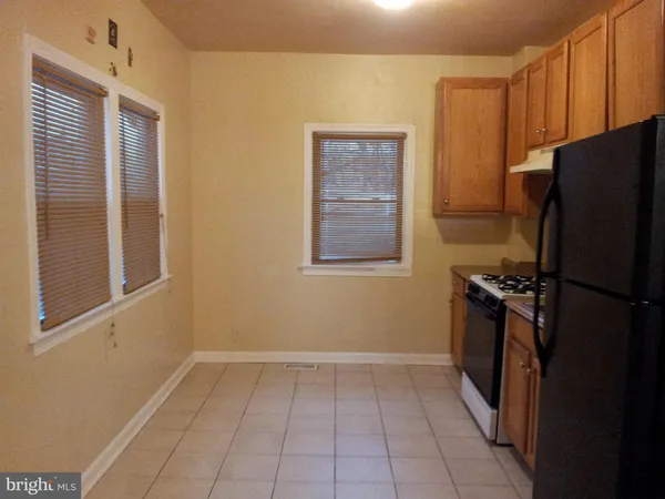 a kitchen with a refrigerator and window